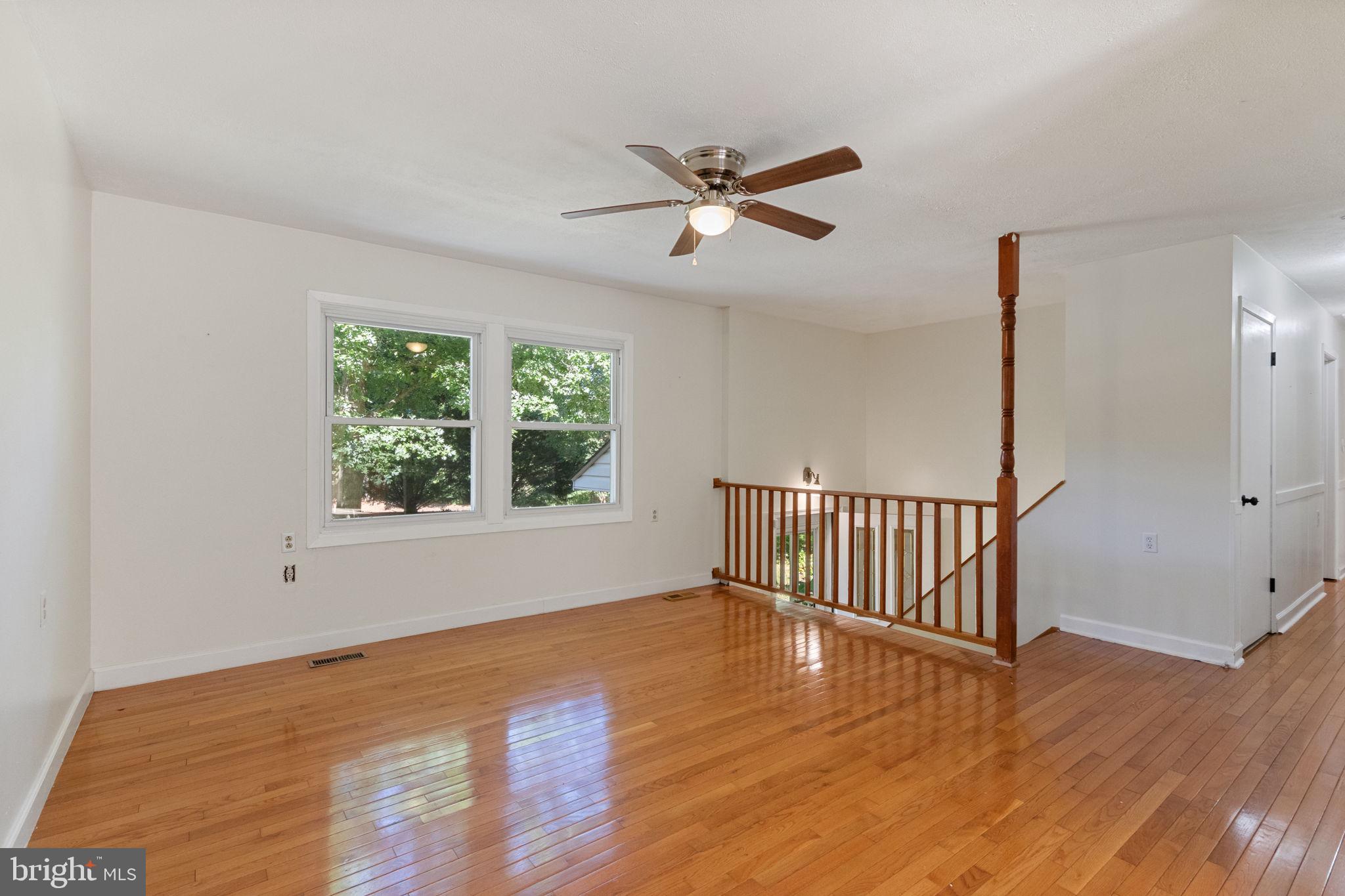 6035 Towles Mill Road Partlow, VA 22534 - Photo 17 of 66 a view of an empty room with wooden floor and a window