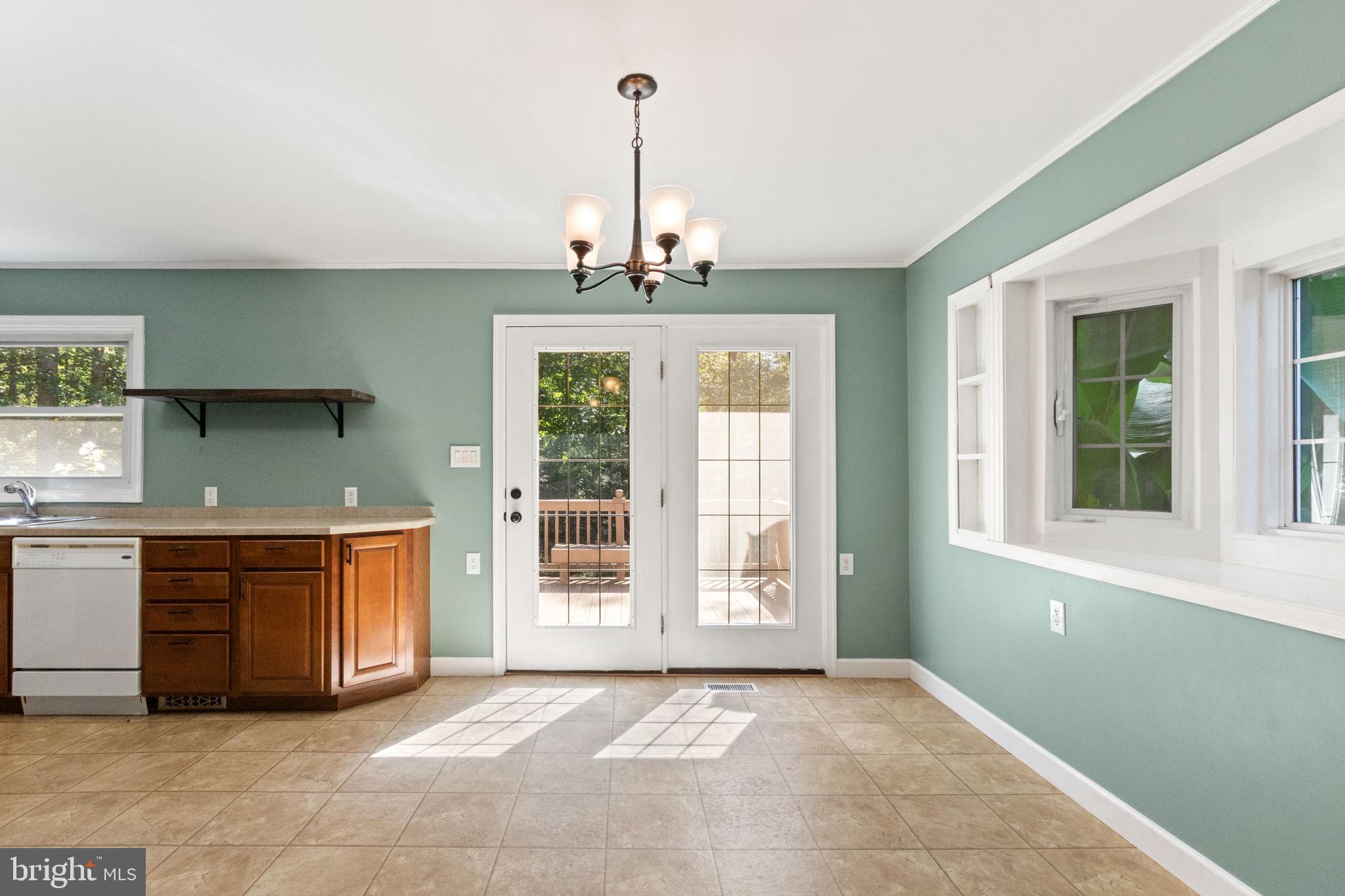 6035 Towles Mill Road Partlow, VA 22534 - Photo 18 of 66 a view of a kitchen with a sink a kitchen island a window and a fireplace