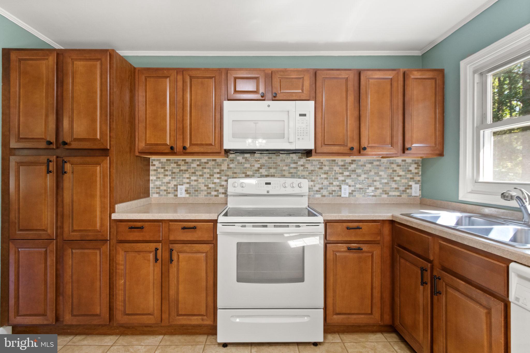 6035 Towles Mill Road Partlow, VA 22534 - Photo 23 of 66 a kitchen with a sink stove and cabinets