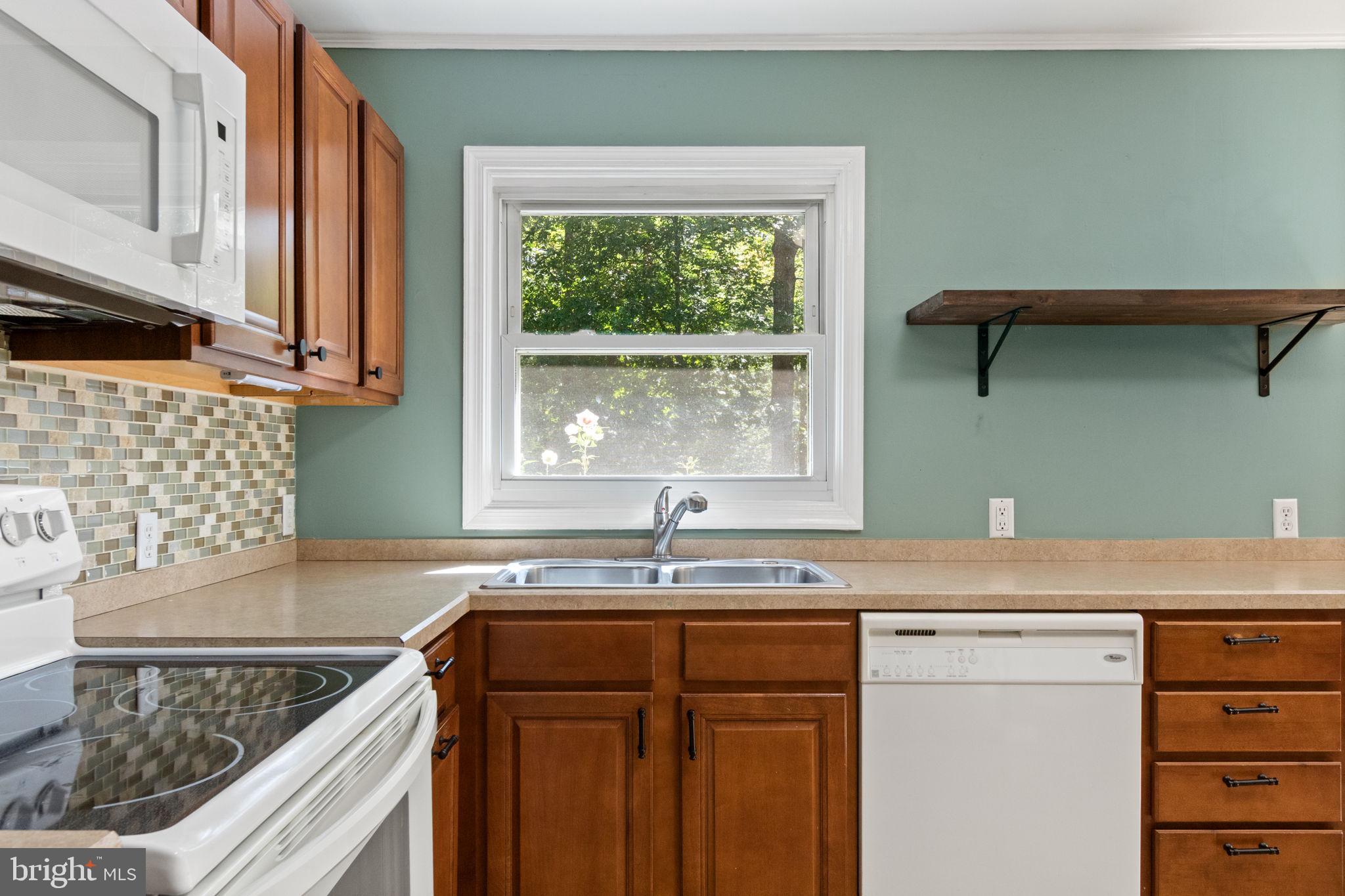 6035 Towles Mill Road Partlow, VA 22534 - Photo 24 of 66 a kitchen with granite countertop a sink and a window