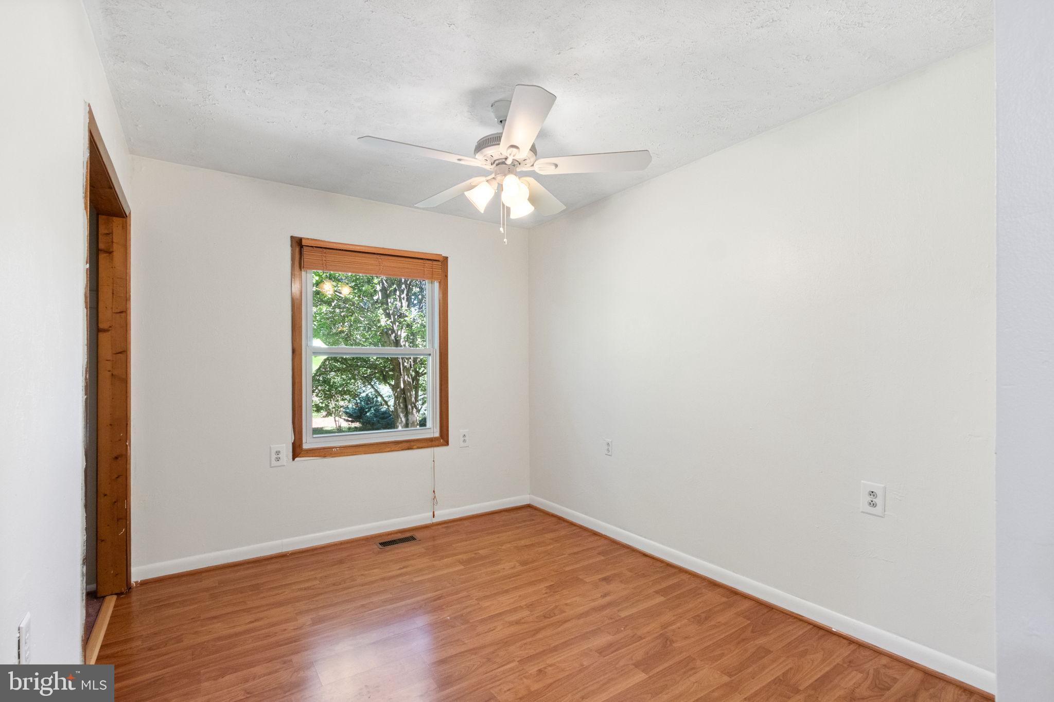 6035 Towles Mill Road Partlow, VA 22534 - Photo 27 of 66 an empty room with windows and fan