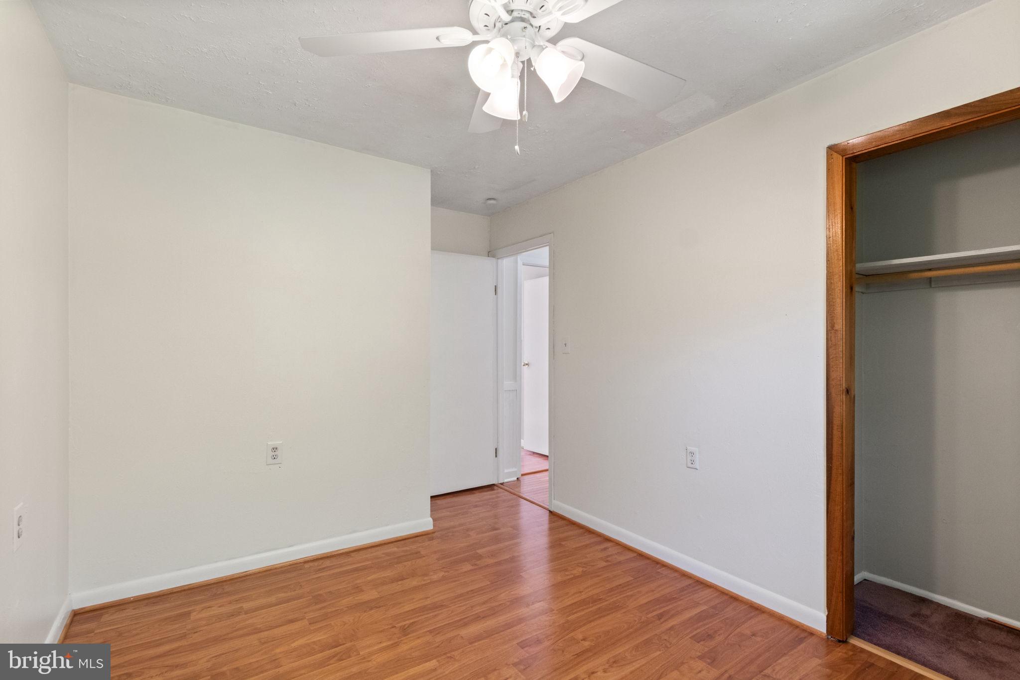 6035 Towles Mill Road Partlow, VA 22534 - Photo 28 of 66 an empty room with wooden floor closet and windows