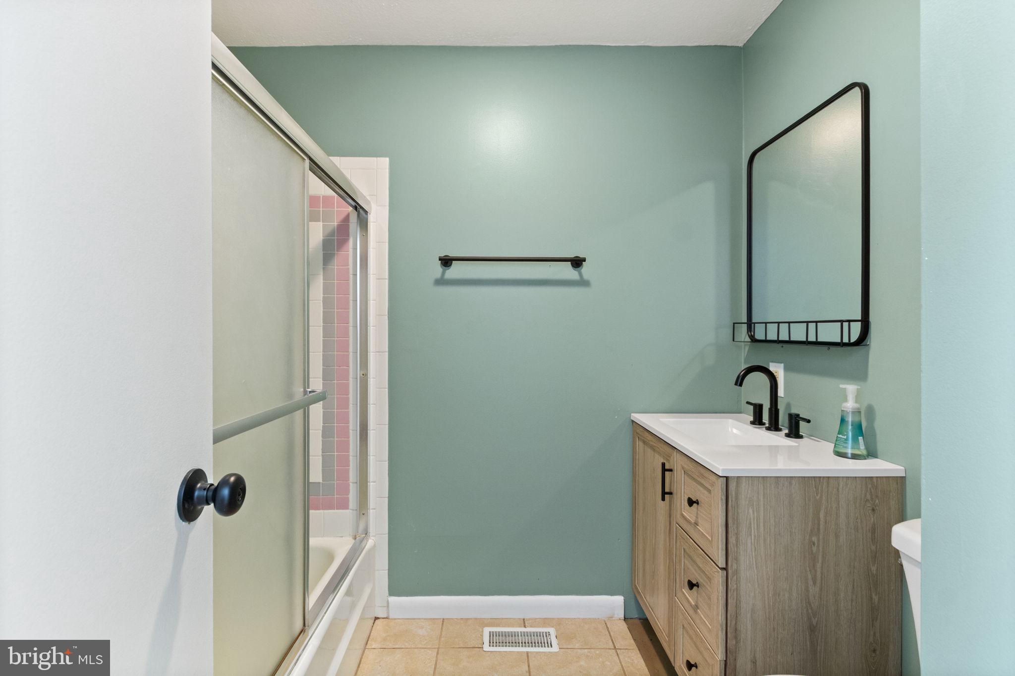 6035 Towles Mill Road Partlow, VA 22534 - Photo 32 of 66 a bathroom with a sink and mirror