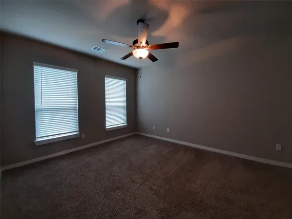 a view of a livingroom with a ceiling fan and window