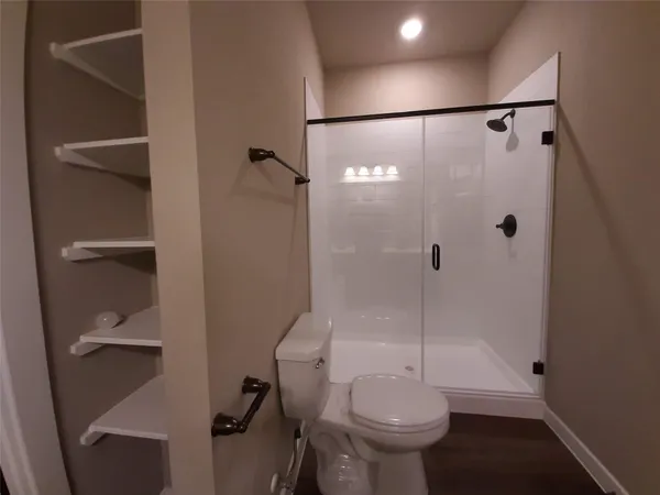 a bathroom with a shower and toilet