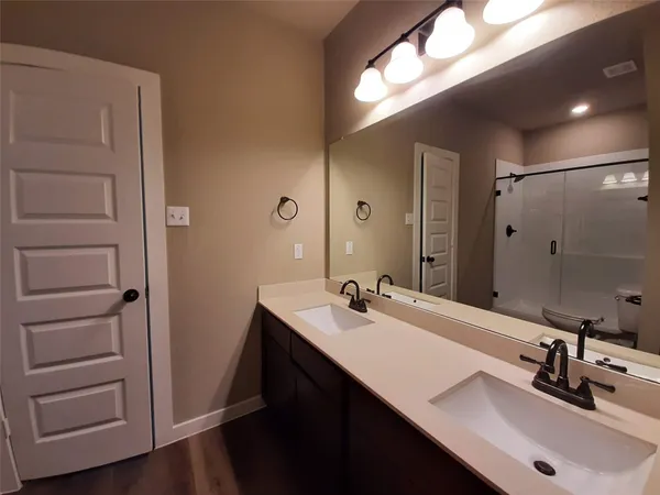 a bathroom with a sink double vanity and a mirror