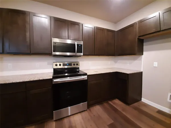 a kitchen with a refrigerator and a stove