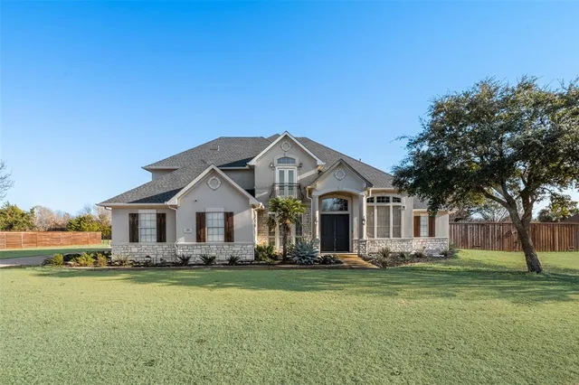 a front view of house with yard and green space