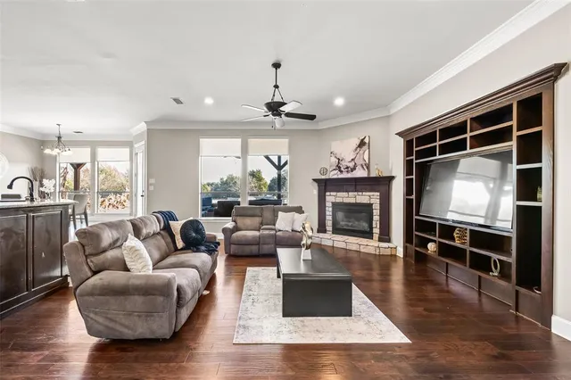 a living room with furniture a fireplace and a flat screen tv