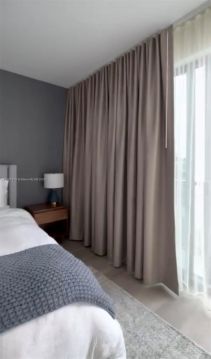 229 Southwest 9th Street, Unit 403 Miami, FL 33130 - Photo 3 of 7 a bedroom with a bed and a window