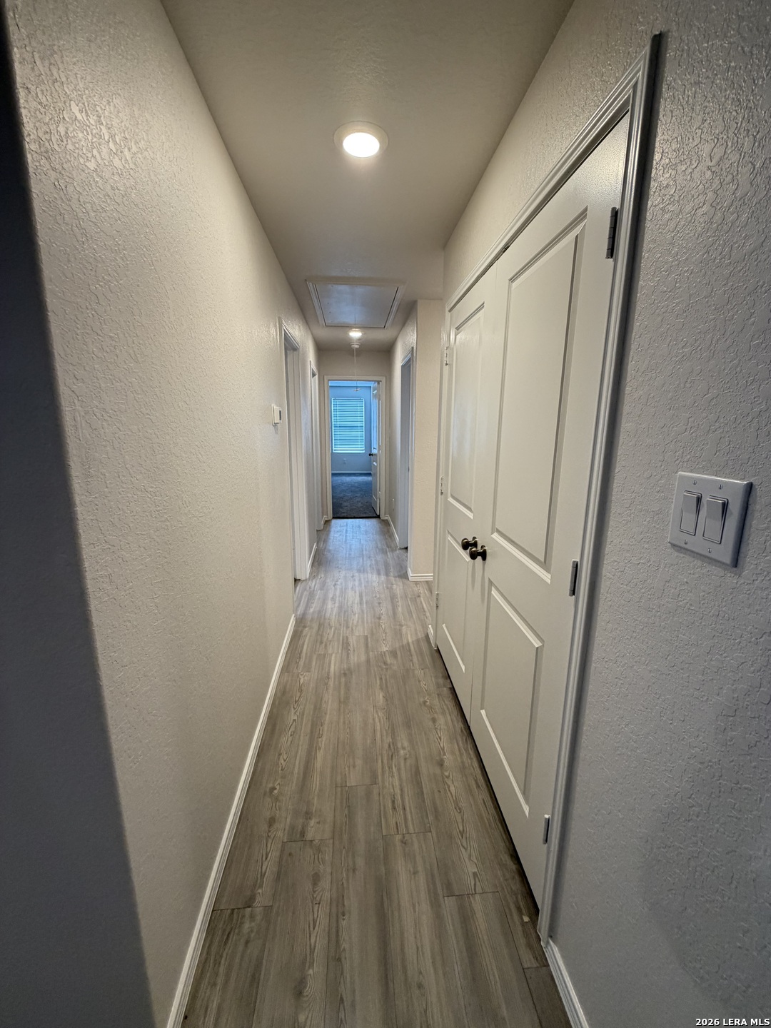 12914 Chinali St. Hedwig, TX 78152 - Photo 11 of 27 a view of a hallway with wooden floor and staircase