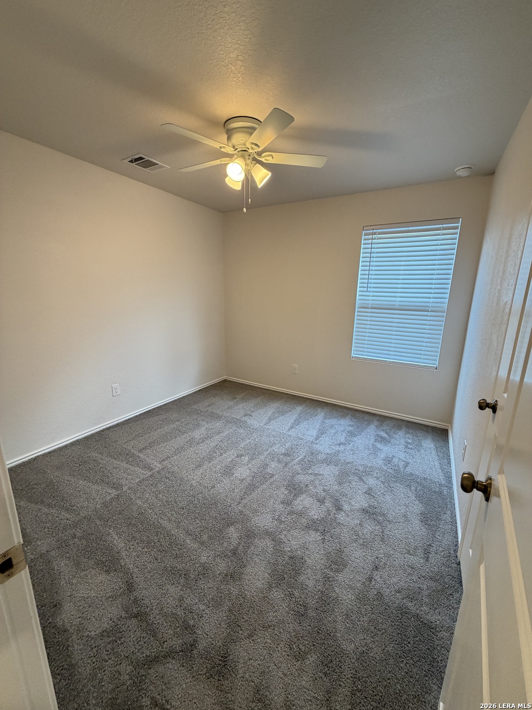 12914 Chinali St. Hedwig, TX 78152 - Photo 12 of 27 an empty room with windows and fan