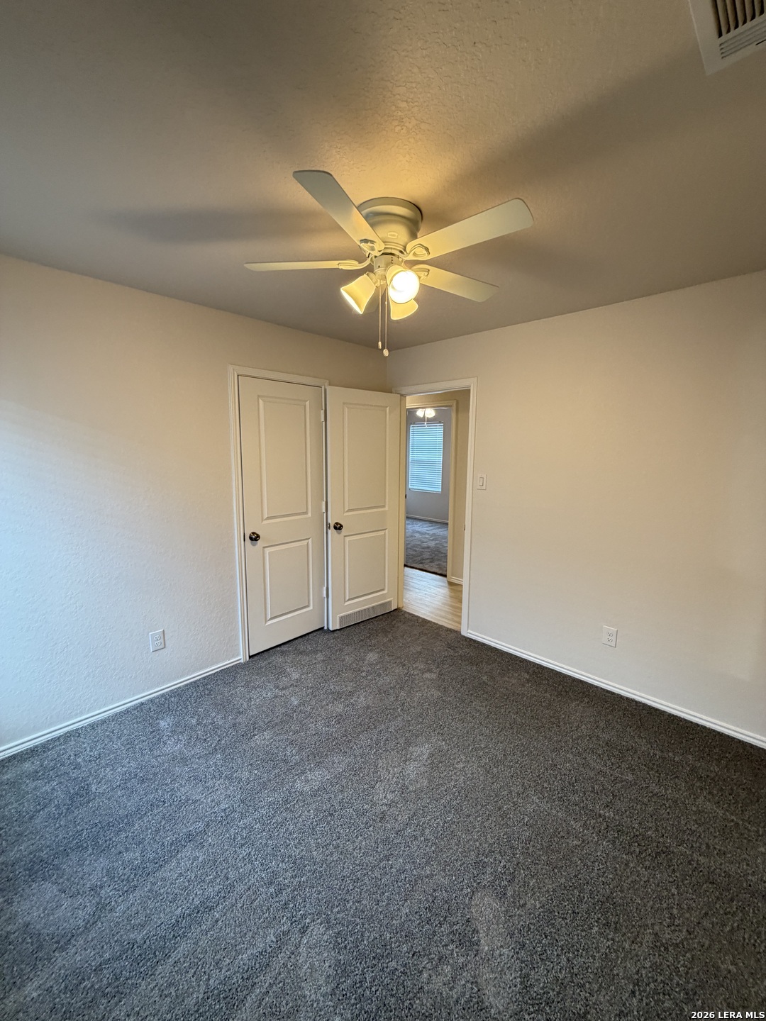 12914 Chinali St. Hedwig, TX 78152 - Photo 13 of 27 a view of an empty room and a ceiling fan