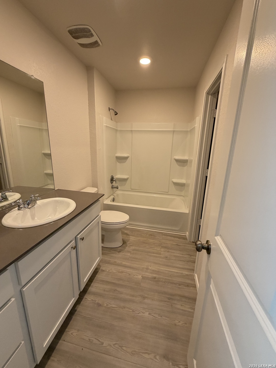 12914 Chinali St. Hedwig, TX 78152 - Photo 21 of 27 a bathroom with a sink a toilet a mirror and shower