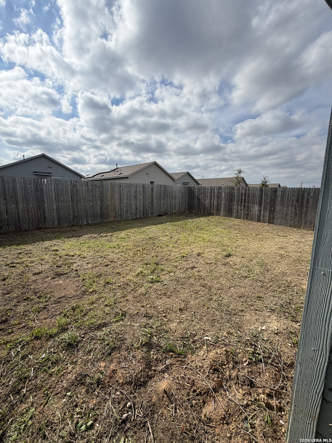 12914 Chinali St. Hedwig, TX 78152 - Photo 27 of 27 a view of a yard with wooden fence