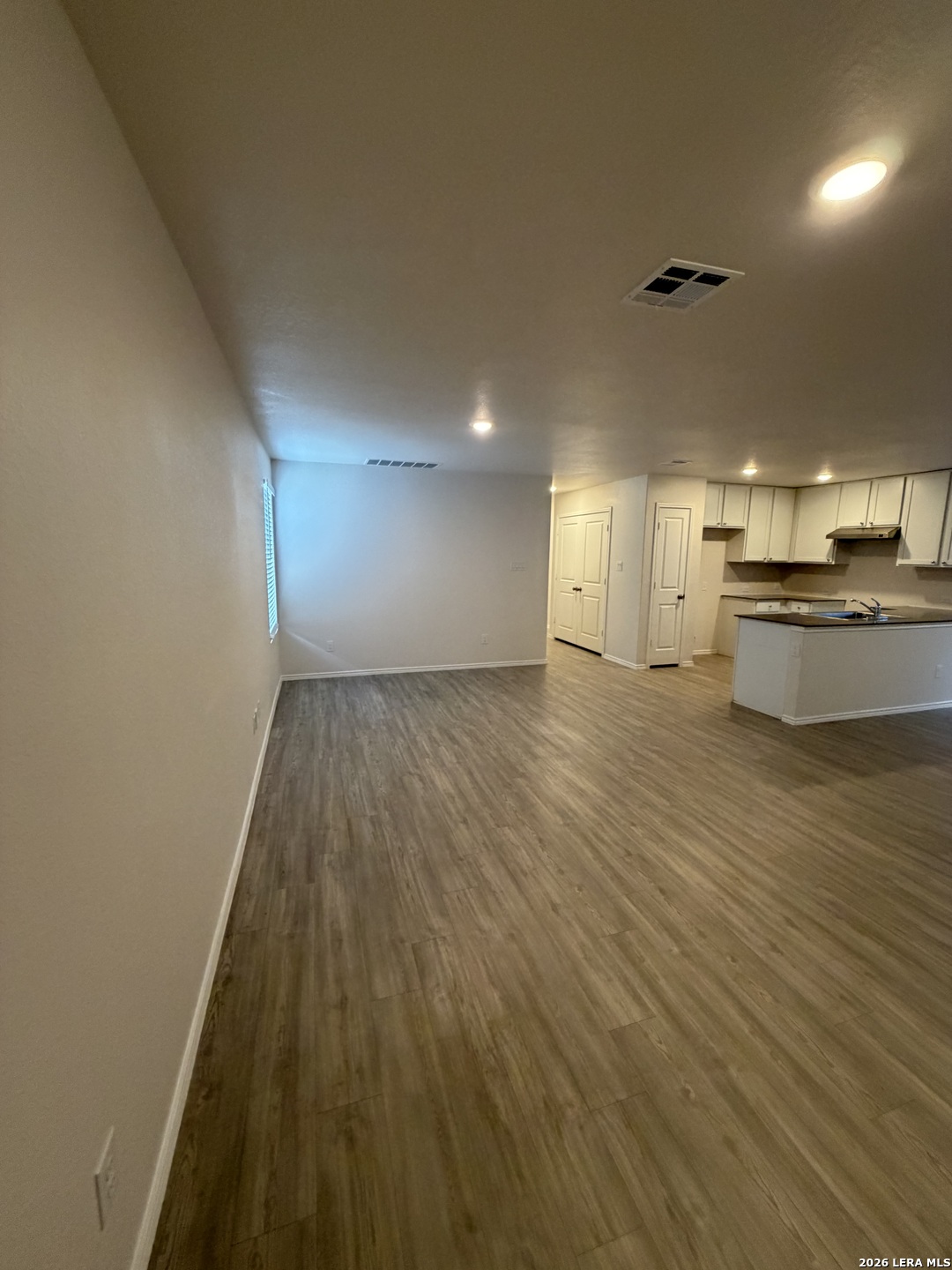 12914 Chinali St. Hedwig, TX 78152 - Photo 4 of 27 an empty room with wooden floor and windows