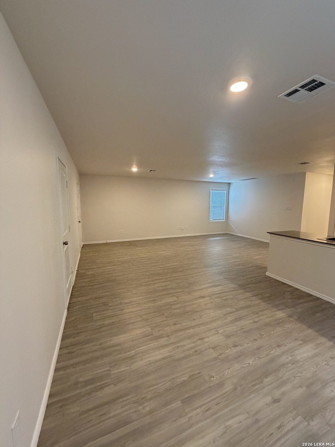 12914 Chinali St. Hedwig, TX 78152 - Photo 6 of 27 an empty room with wooden floor and windows
