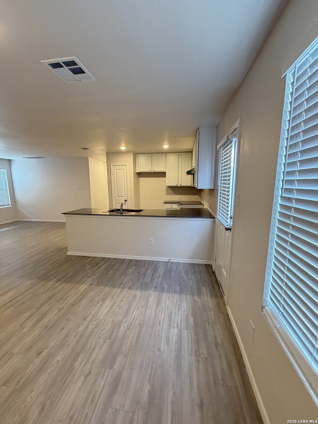 12914 Chinali St. Hedwig, TX 78152 - Photo 7 of 27 a view of a kitchen with a sink and dishwasher wooden floor