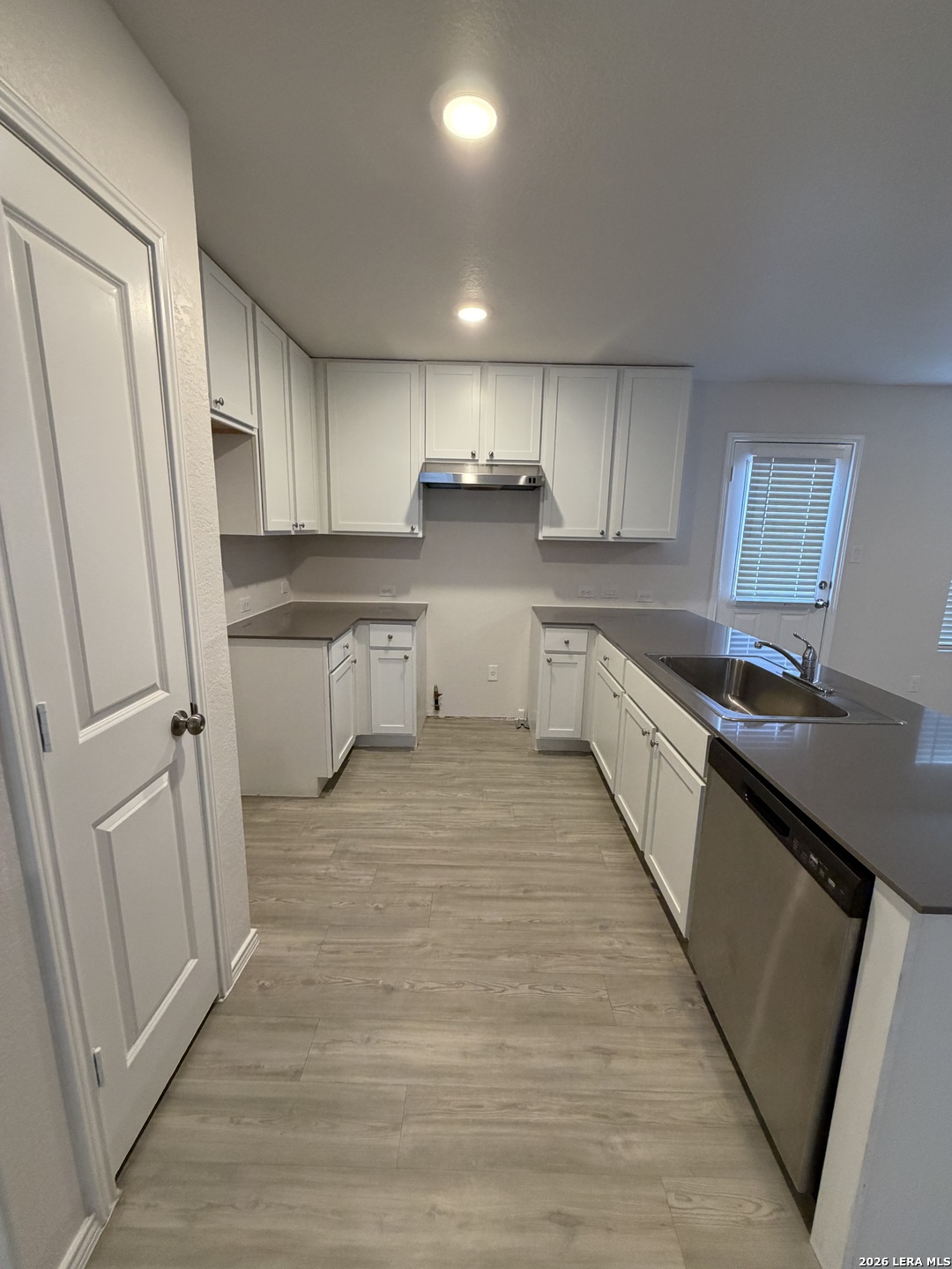 12914 Chinali St. Hedwig, TX 78152 - Photo 8 of 27 a kitchen with white cabinets and sink