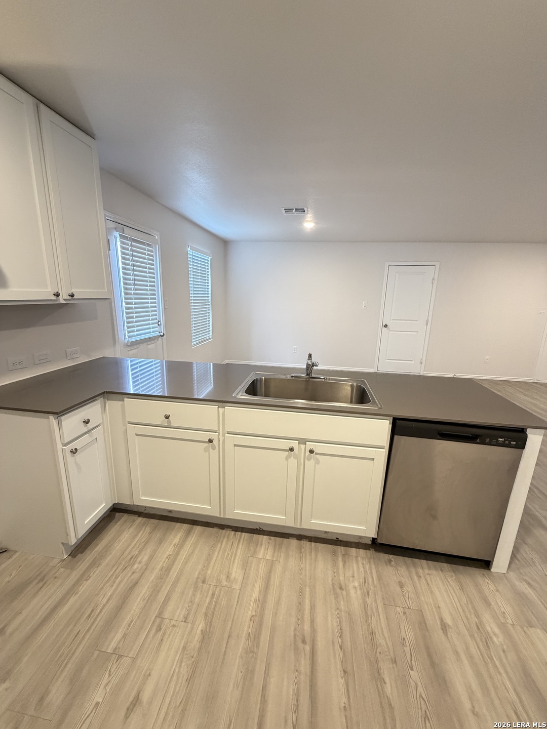 12914 Chinali St. Hedwig, TX 78152 - Photo 10 of 27 a kitchen with sink a microwave and cabinets