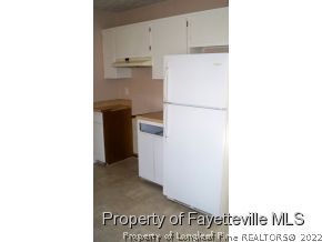 2283 Hackney Loop Fayetteville, NC 28304 - Photo 5 of 14 a kitchen with a refrigerator and a stove