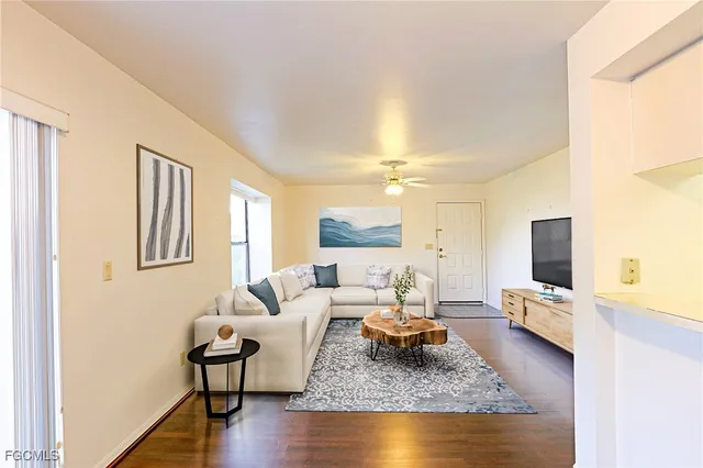 a swimming pool with outdoor seating and yard in the back
