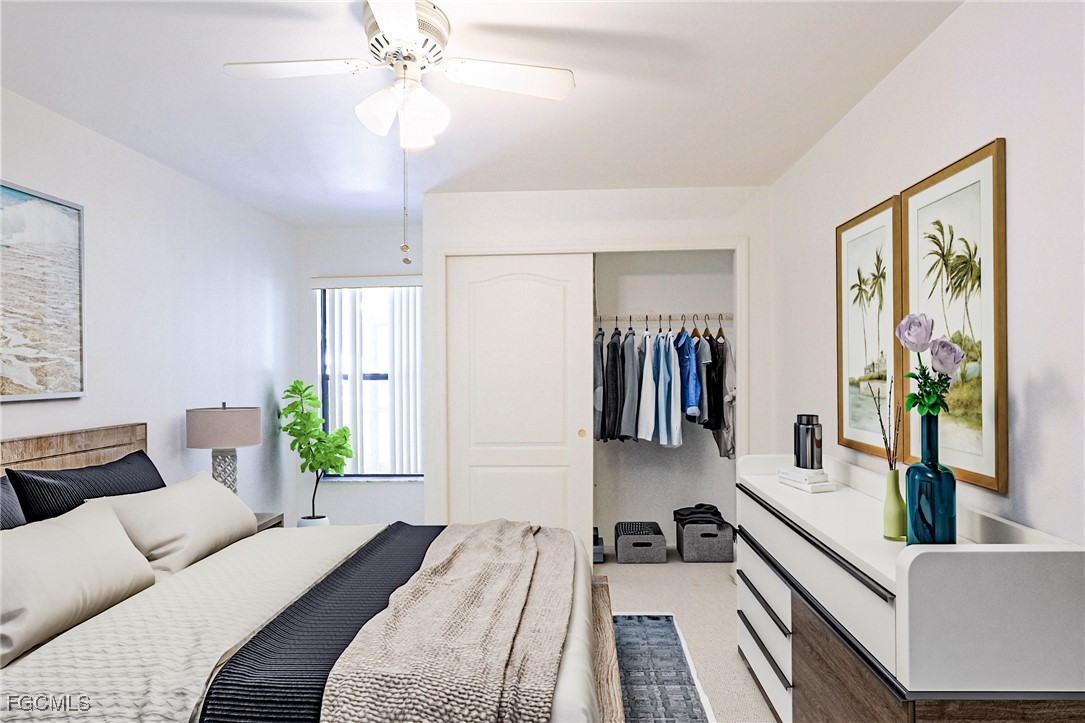 13220 Whitehaven Lane, Unit 1402 Fort Myers, FL 33966 - Photo 25 of 43 a bedroom with a large bed and a chandelier