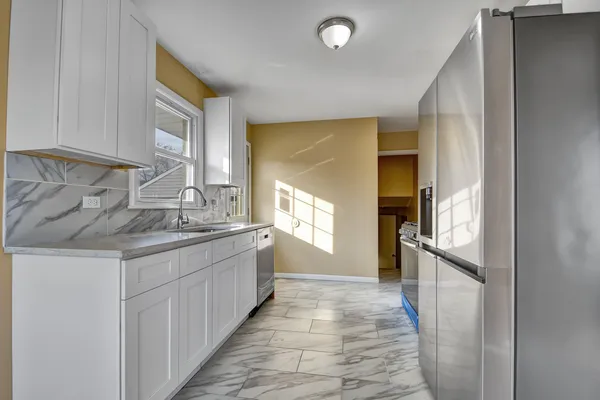 a kitchen with granite countertop a sink and cabinets