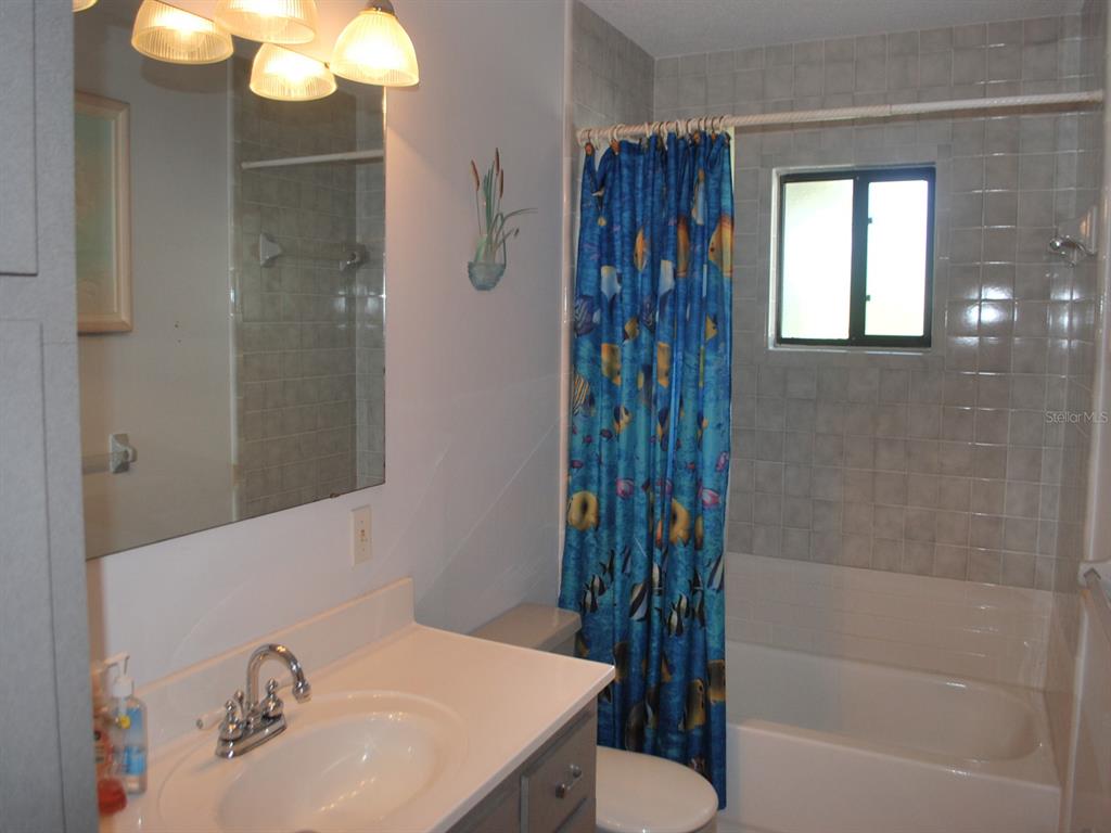 117 Poinciana Road Edgewater, FL 32141 - Photo 12 of 15 a bathroom with a sink and a mirror