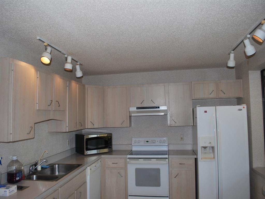 117 Poinciana Road Edgewater, FL 32141 - Photo 6 of 15 a kitchen with a sink a stove and refrigerator