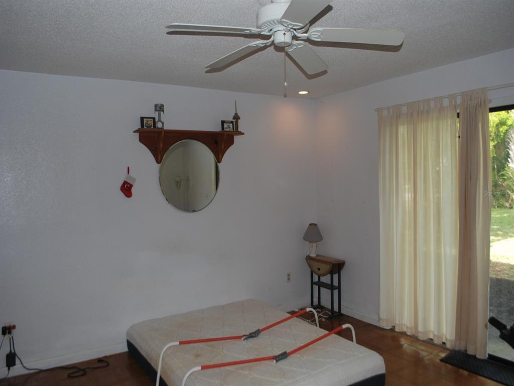 117 Poinciana Road Edgewater, FL 32141 - Photo 10 of 15 a bedroom with a bed and a chandelier