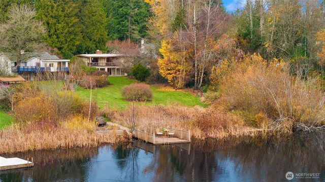 a view of a house with a yard and sitting area