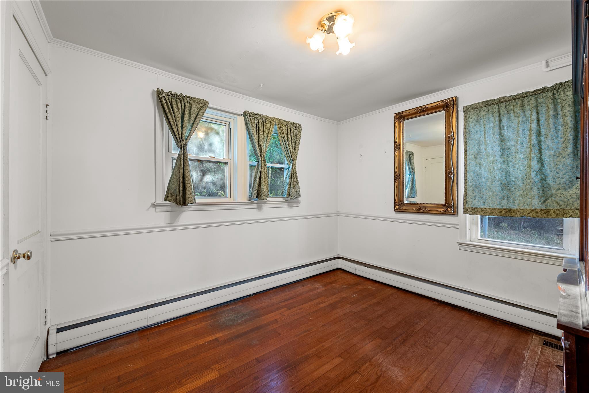 1621 Locke's Mill Road Berryville, VA 22611 - Photo 22 of 54 wooden floor in an empty room with a window