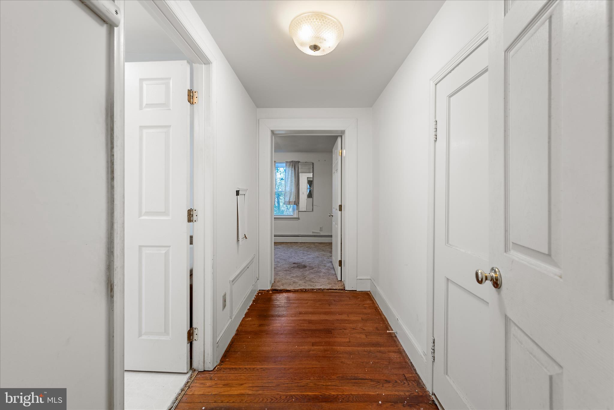 1621 Locke's Mill Road Berryville, VA 22611 - Photo 23 of 54 a view of a hallway with wooden floor and a bathroom