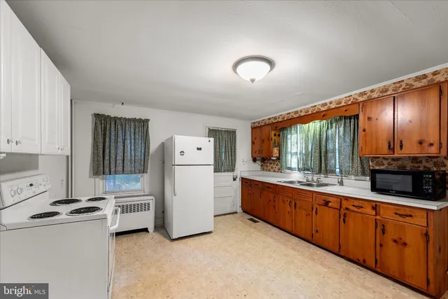 a view of a house with a large window and wooden fence