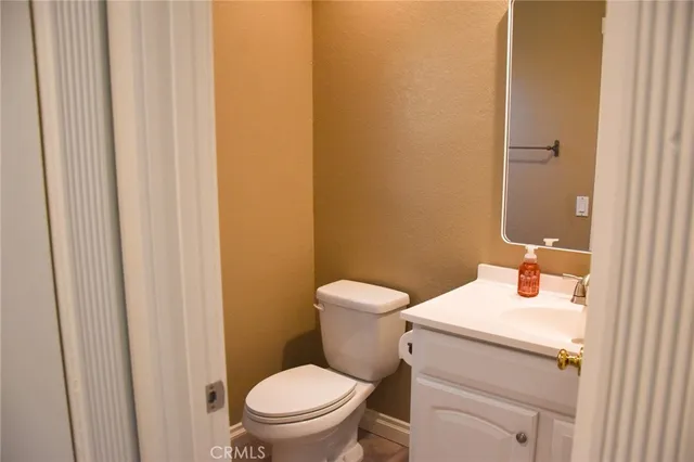 a white toilet sitting next to a bathroom sink