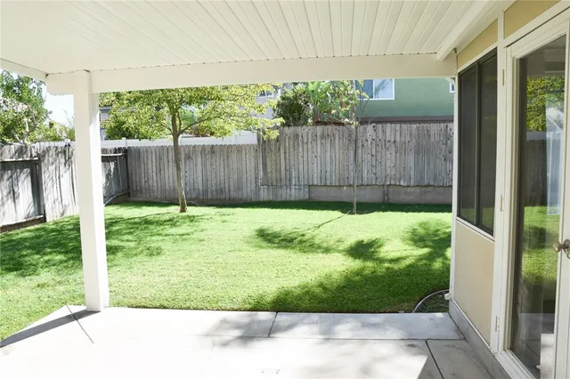 a view of backyard with tub and trees in the background