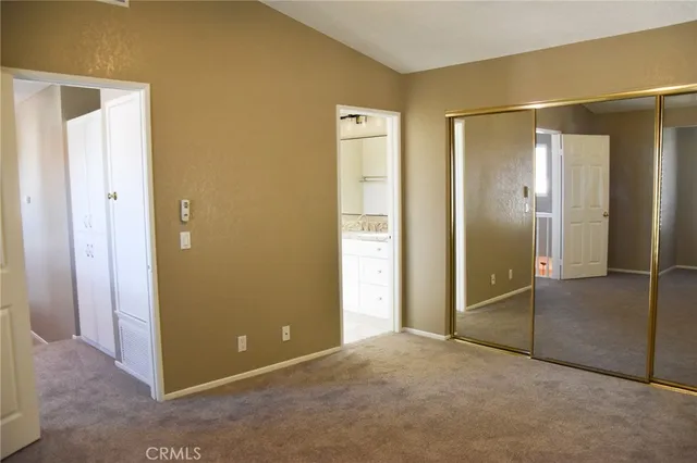 an empty room with windows and closet