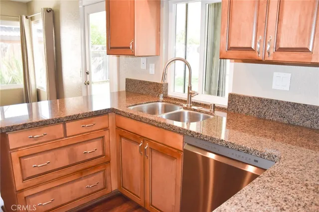 a kitchen with granite countertop a sink and cabinets