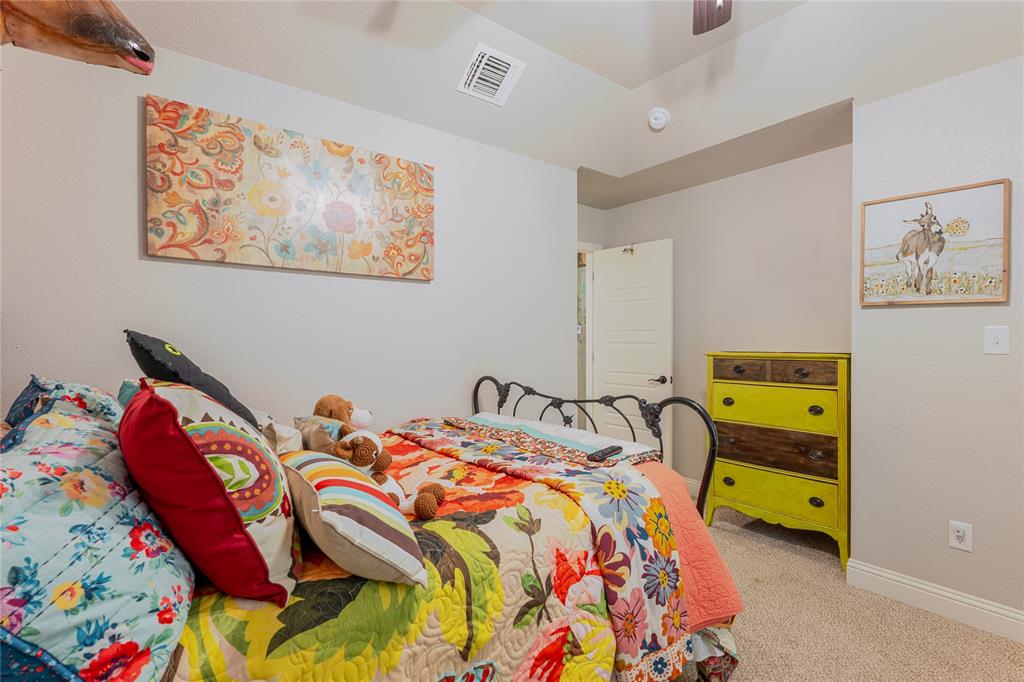 470 Wilson Bend Road Millsap, TX 76066 - Photo 25 of 39 a bedroom with two beds and a painting on the wall