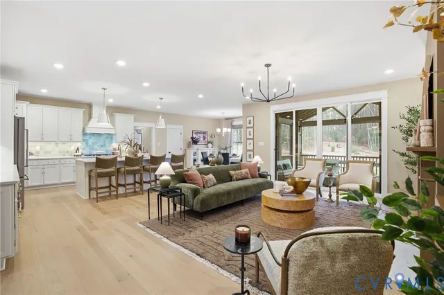 a living room with furniture dining table and a large window