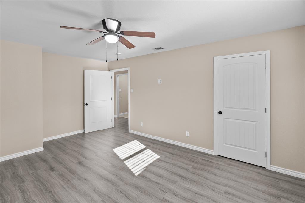 170 High Ridge Drive Azle, TX 76020 - Photo 16 of 36 an empty room with wooden floor and ceiling fan