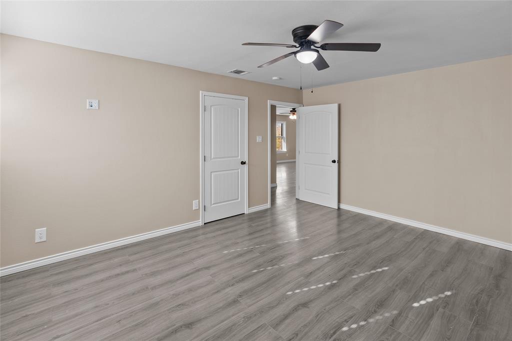 170 High Ridge Drive Azle, TX 76020 - Photo 18 of 36 a view of a room with wooden floor and a ceiling fan