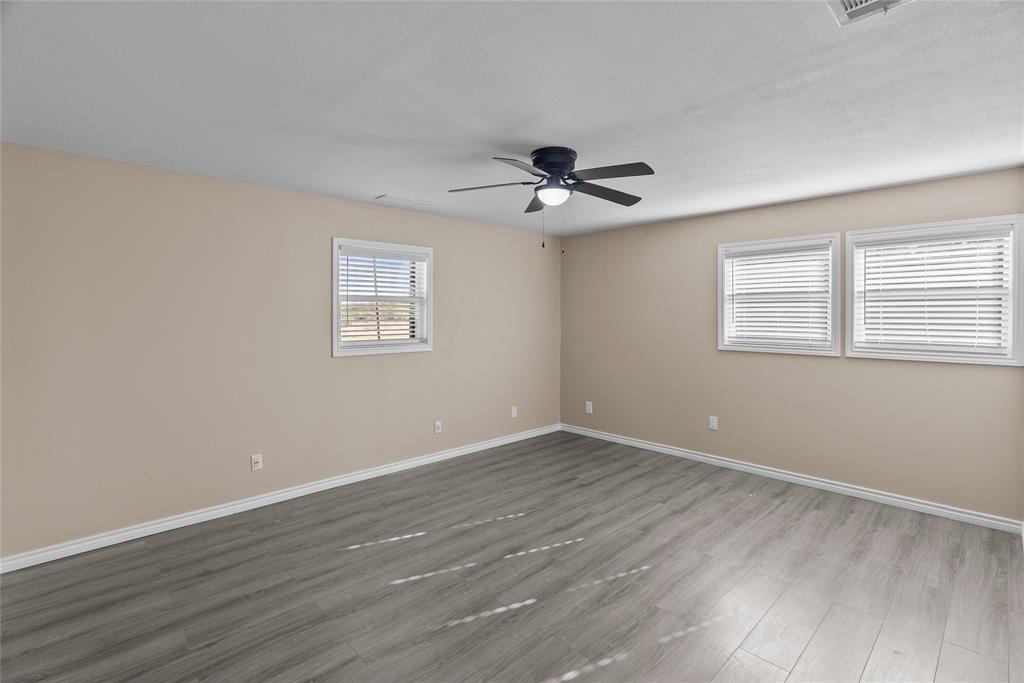 170 High Ridge Drive Azle, TX 76020 - Photo 19 of 36 a view of an empty room with a window and wooden floor