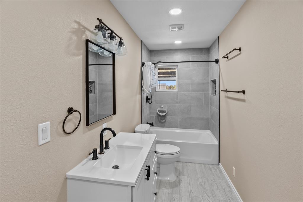 170 High Ridge Drive Azle, TX 76020 - Photo 20 of 36 a bathroom with a bathtub shower sink and toilet
