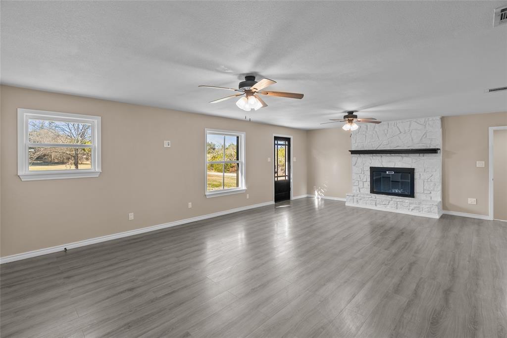 170 High Ridge Drive Azle, TX 76020 - Photo 3 of 36 a view of an empty room with a fireplace and a window