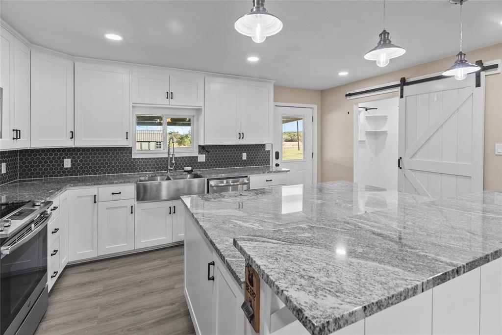 170 High Ridge Drive Azle, TX 76020 - Photo 5 of 36 a kitchen with stainless steel appliances granite countertop a sink stove and refrigerator