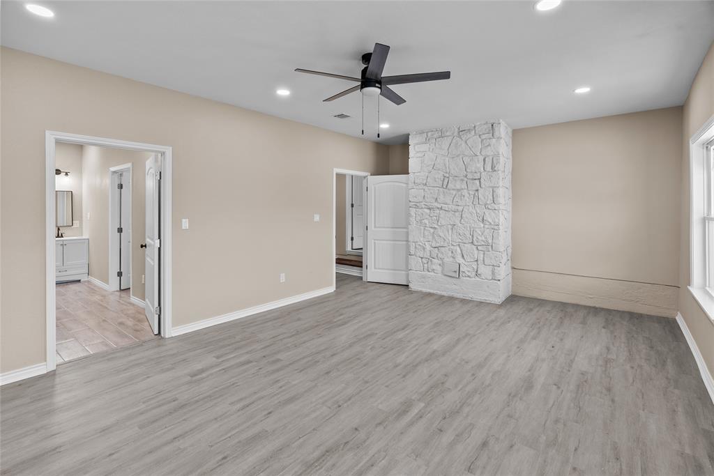 170 High Ridge Drive Azle, TX 76020 - Photo 10 of 36 an empty room with wooden floor and a ceiling fan
