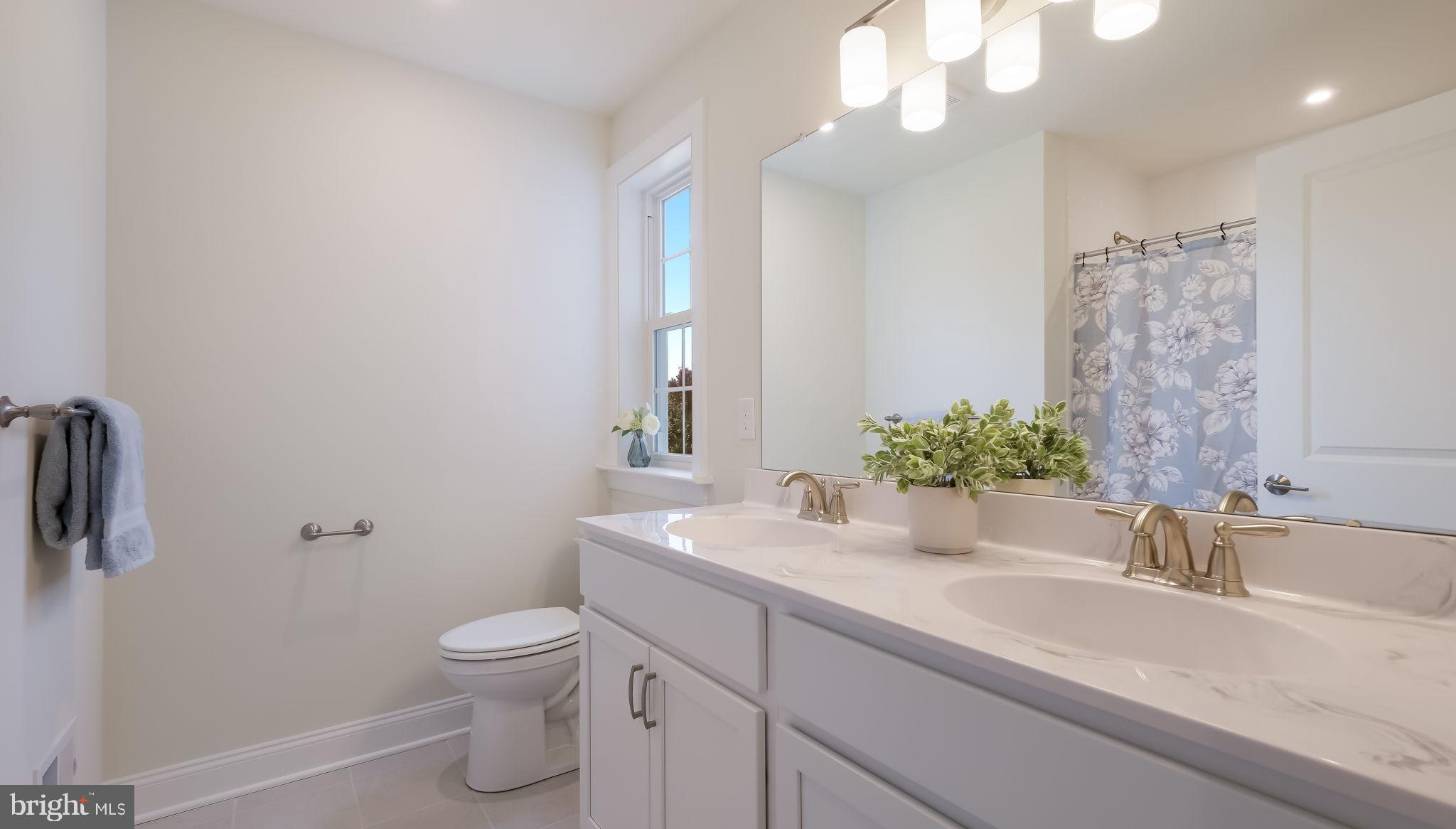 1205 Jordan Lane Perkasie, PA 18944 - Photo 36 of 40 a bathroom with a granite countertop sink a toilet and a mirror