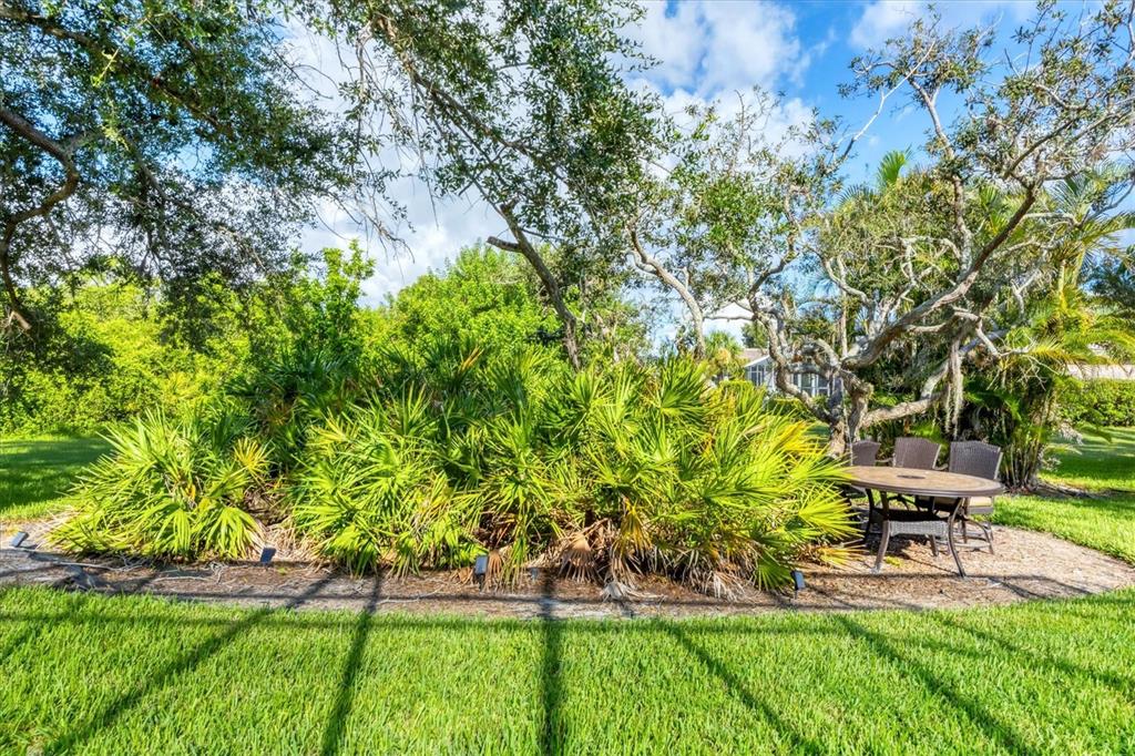 4 Windward Way Placida, FL 33946 - Photo 35 of 39 a garden with a bench and some trees